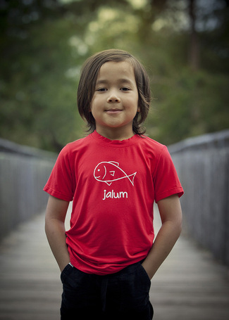 a photo of a child wearing a bundjalung alum fish bamboo t shirt by mini mals