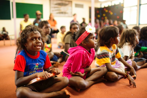a photo of Aboriginal school children studying in first language supported by the wall of hands